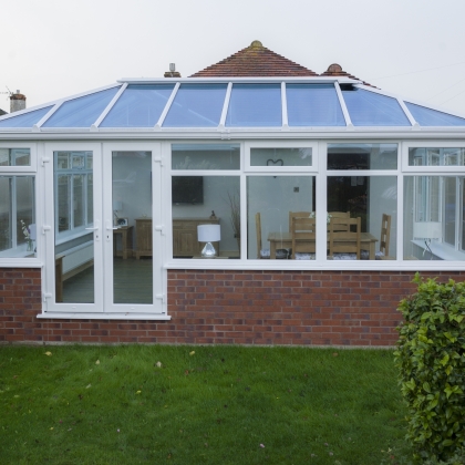 Outside view of a glass and brick uPVC conservatory