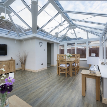 Inside view of a white conservatory with flowers on the table