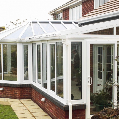 White uPVC extension next to a tree