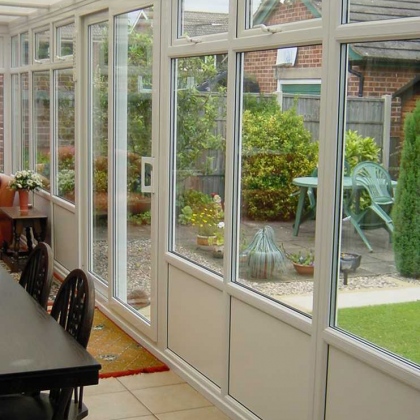 Inside a glazed uPVC extension with table and chairs