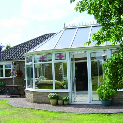 Sunny Glazed extension with tree in the garden