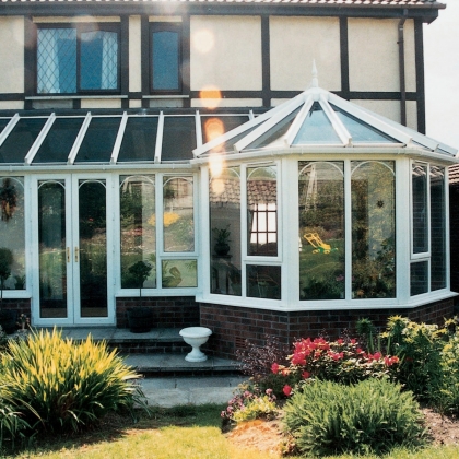 Glazed extension in a bright flowery garden