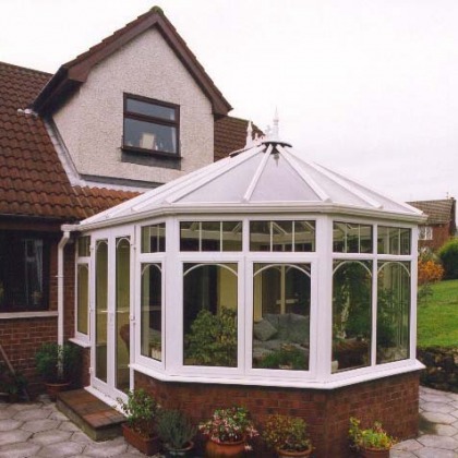 Glazed extension with a garden and flower pots