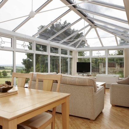 Inside a rehau Glazed extension with Table set and sofa
