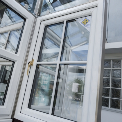 Casement window in a showroom with a brass handle