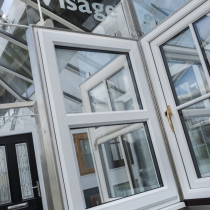 Casement window with a brass handle in a showroom