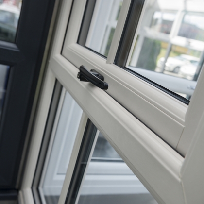 Casement window in a showroom with a black handle