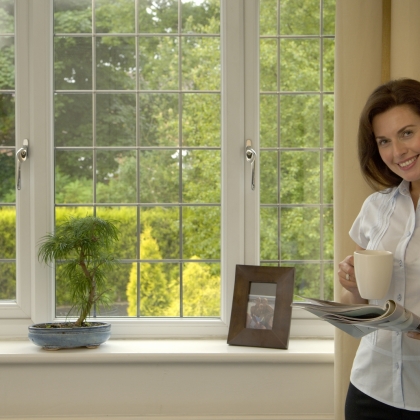 Woman standing in front of a Casement window