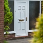 uPVC Entrance door next to a bush