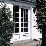 White uPVC door with glazed window with bars