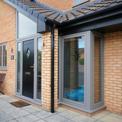 House with PVCu Flush sash bay windows and black front door