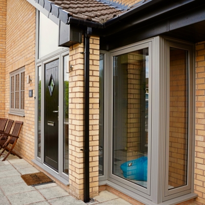 Close up of House with PVCu Flush sash bay windows and black front door