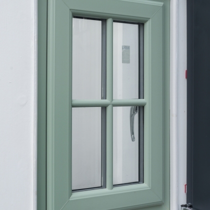 Green Heritage style uPVC window in a showroom