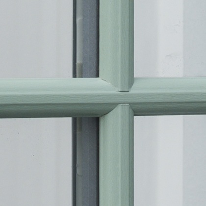 Close up Green Heritage style uPVC window in a showroom
