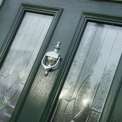 Dual window in a composite door with a knocker