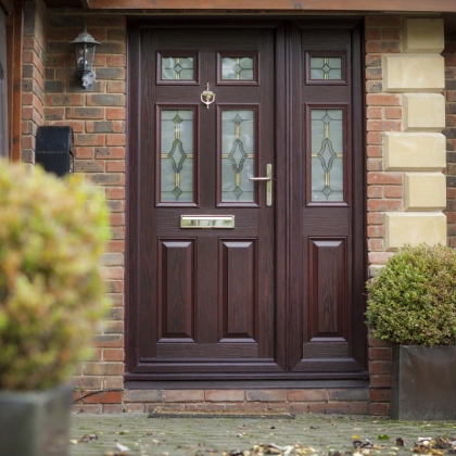 Brown composite door with brass knocker