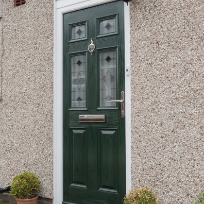 Dark green composite door with silver knocker, letter box and door handle